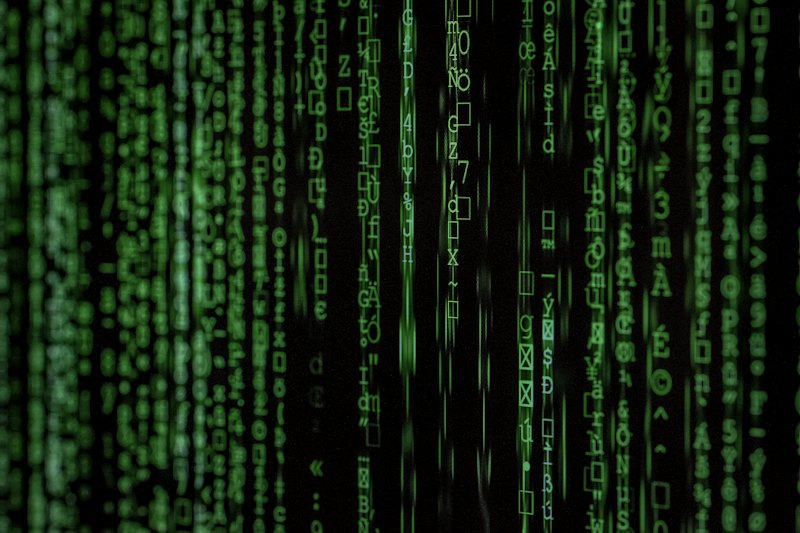 Green matrix-style code streaming across a dark screen